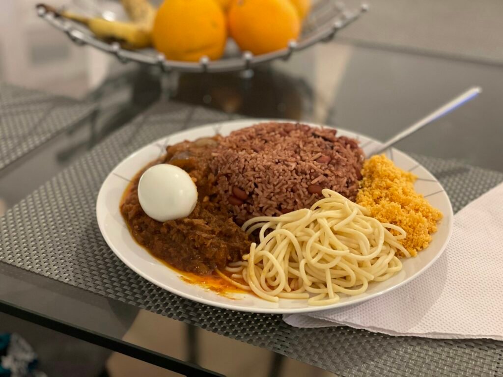 Plate of waakye with spaghetti and egg