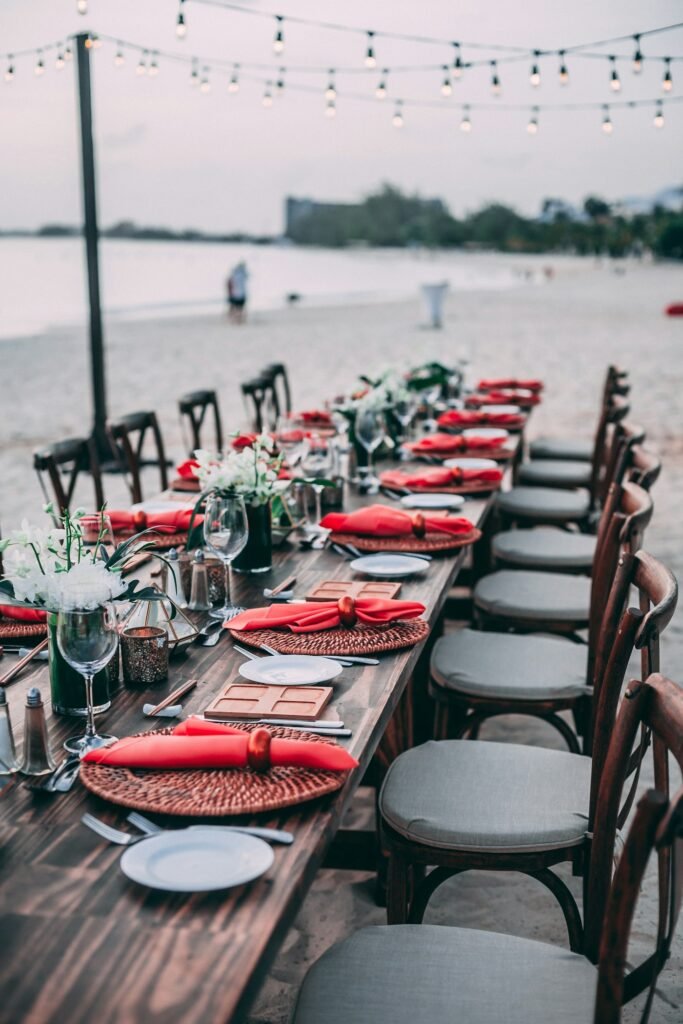 Reception tables set with red napkins and centrepieces