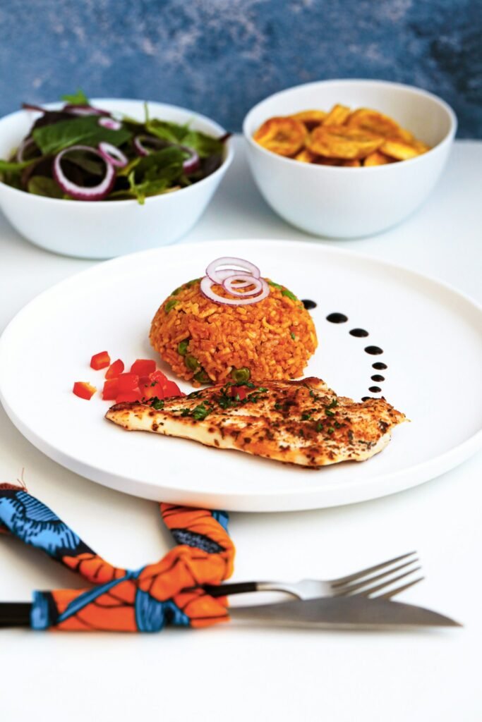 Plate of jollof rice with grilled fish