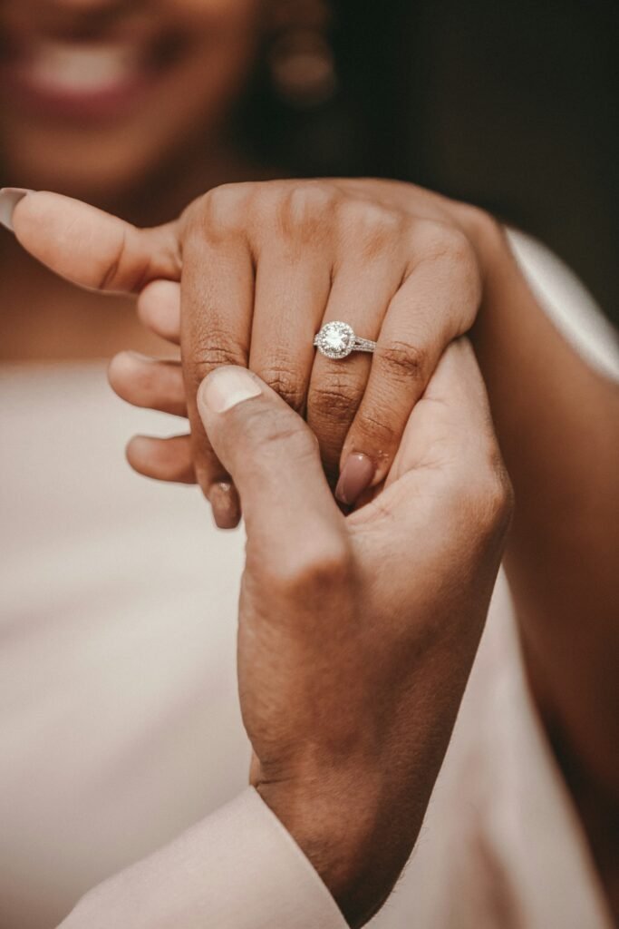 Couple holding hands with wedding rings