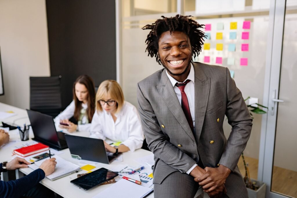 Smiling professional in a modern office with his team