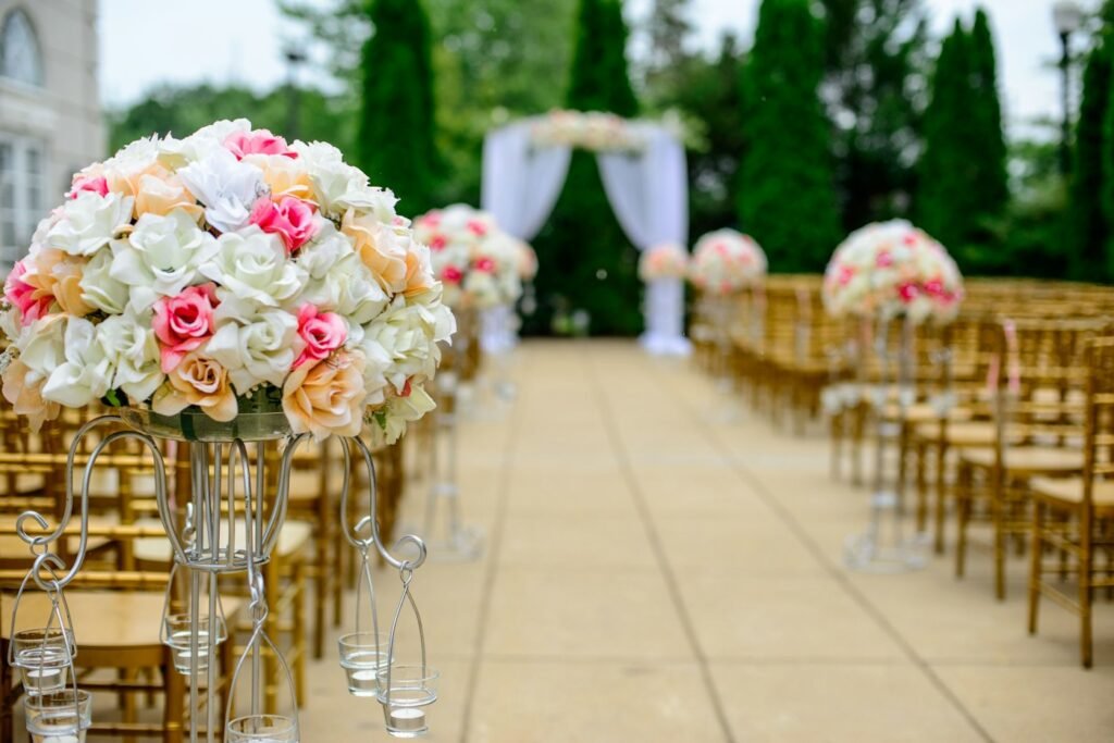 Aisle lined with white and pink flower arrangements